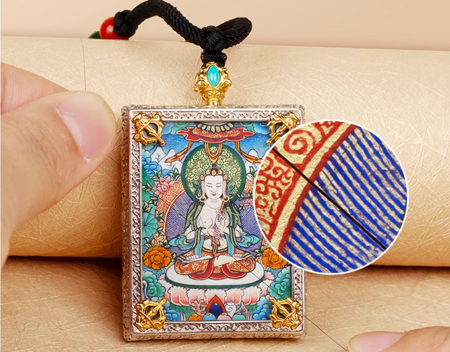 Thangka pendant with intricate hand-painted design and symbolic imagery.
