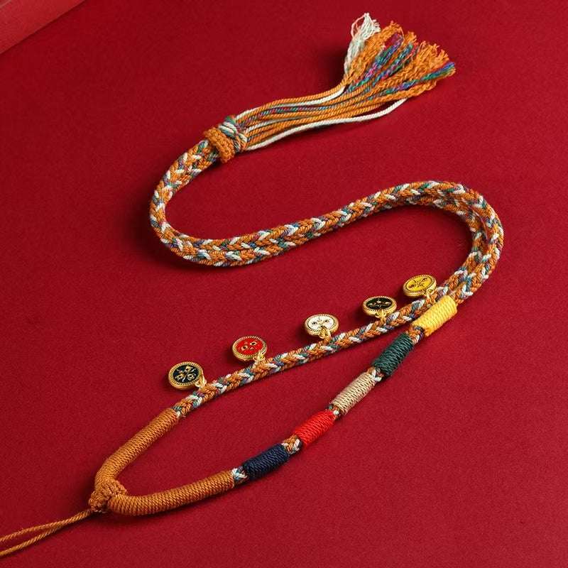 Handwoven Thangka Lanyard with vibrant orange, symbolic threads, and golden beads on red background.