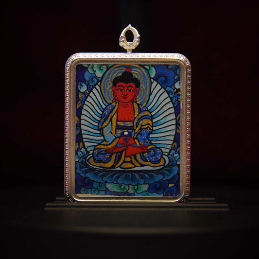 Amitabha Buddha Thangka Pendant depicting hand-painted Buddha in meditation with blue robes and lotus throne, spiritual jewelry.