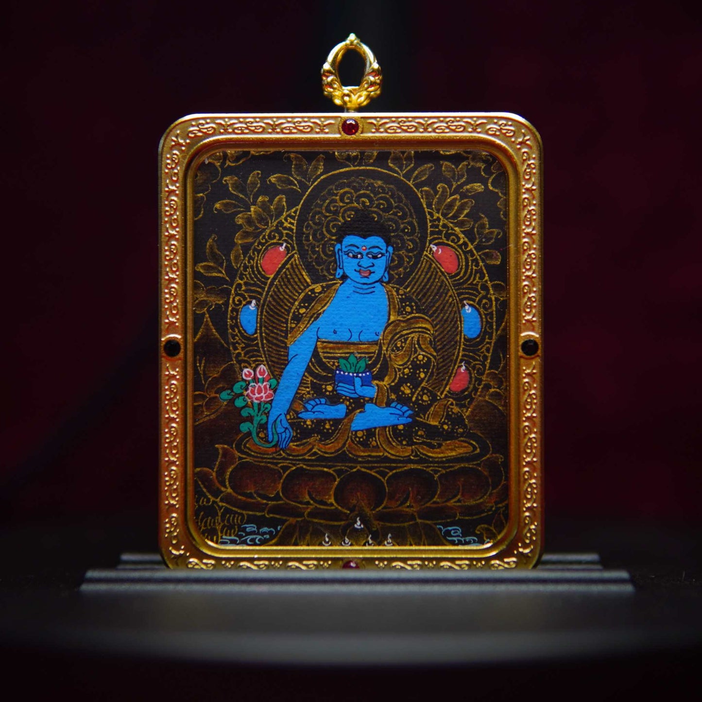 Hand-painted black gold Medicine Buddha Thangka pendant featuring intricate sacred designs and spiritual symbolism.