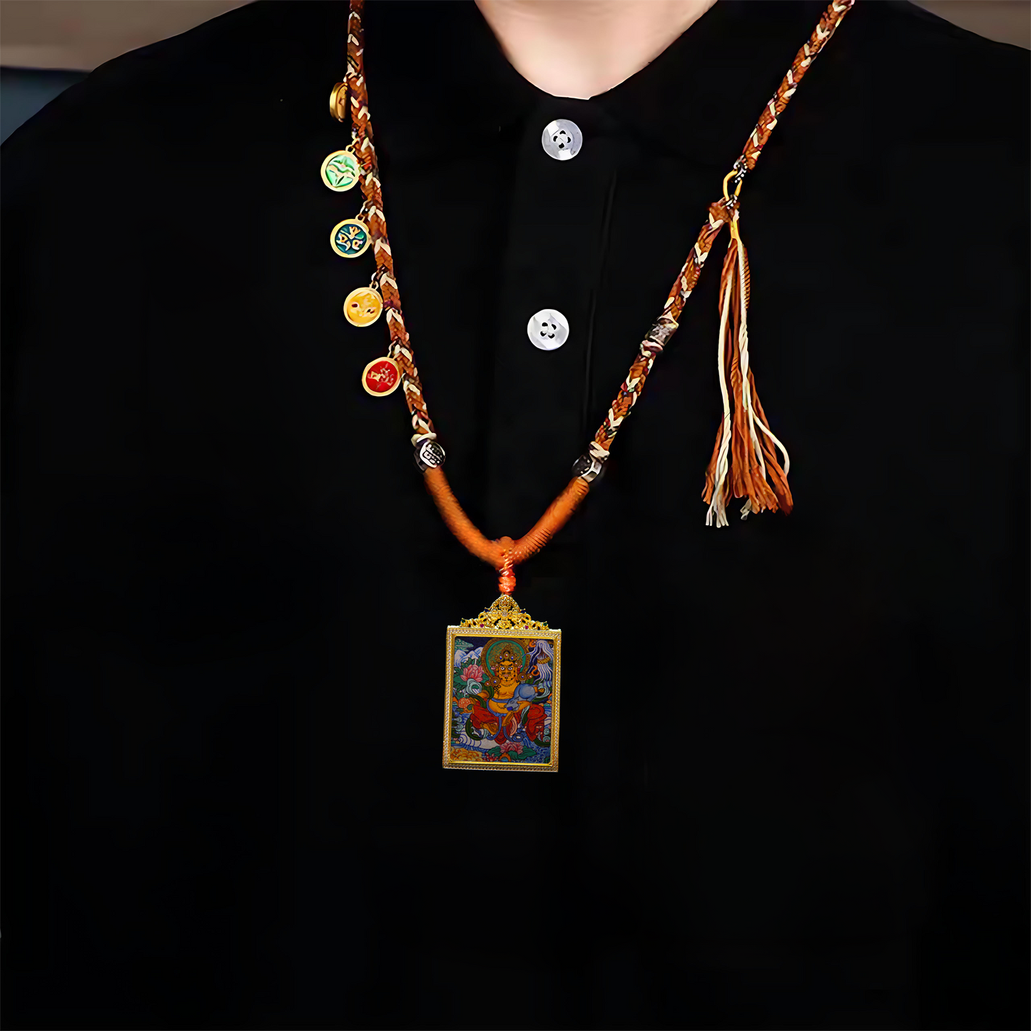 Authentic Hand-Painted Yellow Jambhala Thangka Pendant on braided necklace, showing Buddhist deity with golden complexion, lotus throne, and sacred mongoose.