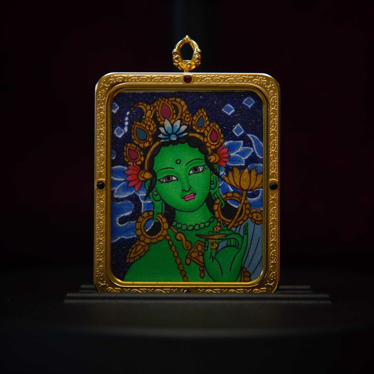 Handmade Green Tara Thangka Pendant with gold-plated frame, featuring the Buddhist goddess on a lotus, symbolizing compassion and protection.