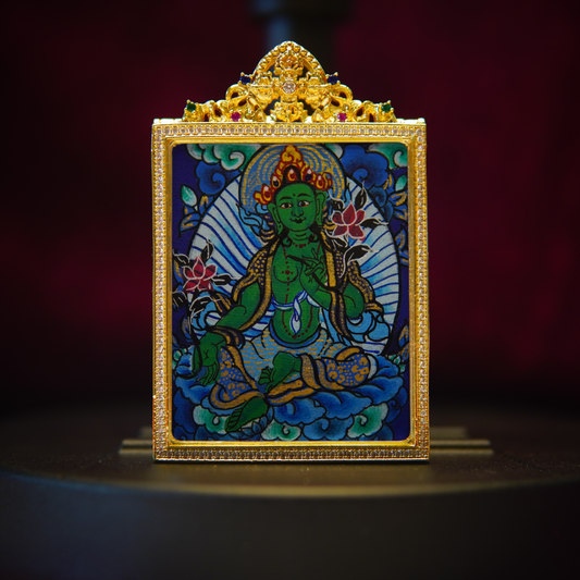 Authentic Green Tara Thangka pendant with gold detailing, depicting the Buddhist goddess of compassion, seated on a blue and gold background.