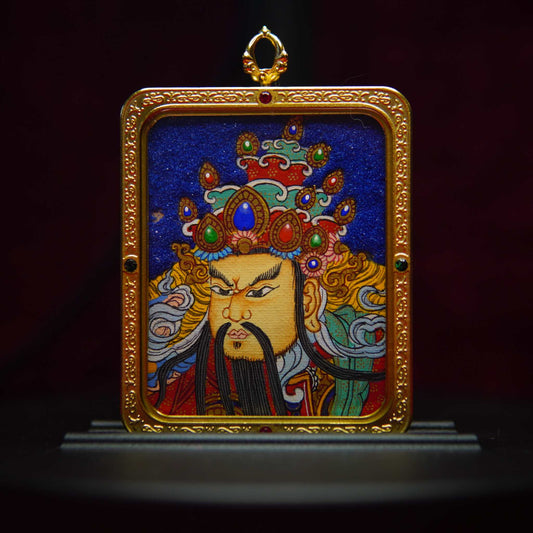 Guan Gong Thangka pendant with hand-painted warrior art in gold frame, symbolizes protection and victory.