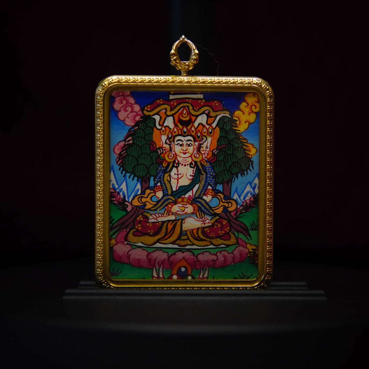 Hand-painted Vairocana Buddha thangka pendant featuring intricate Tibetan Buddhist art on a lotus throne with vibrant colors and 24K gold accents.