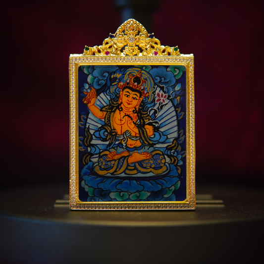 Sacred Wisdom Pendant featuring Manjushri Bodhisattva in meditation, adorned with a fiery sword and lotus, encased in a gold frame.