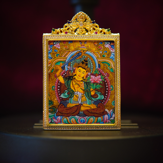 Hand-painted Manjushri Wisdom Buddha pendant with vibrant colors and intricate gold frame, symbolizing clarity and spiritual growth.