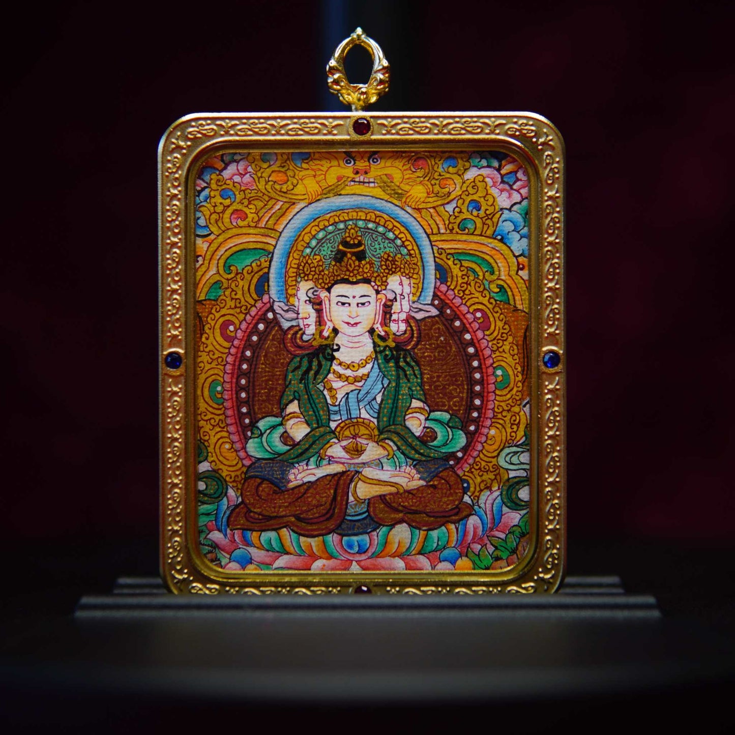 Hand-painted Vairocana Buddha Thangka pendant with intricate detailing, showcasing traditional Tibetan craftsmanship.