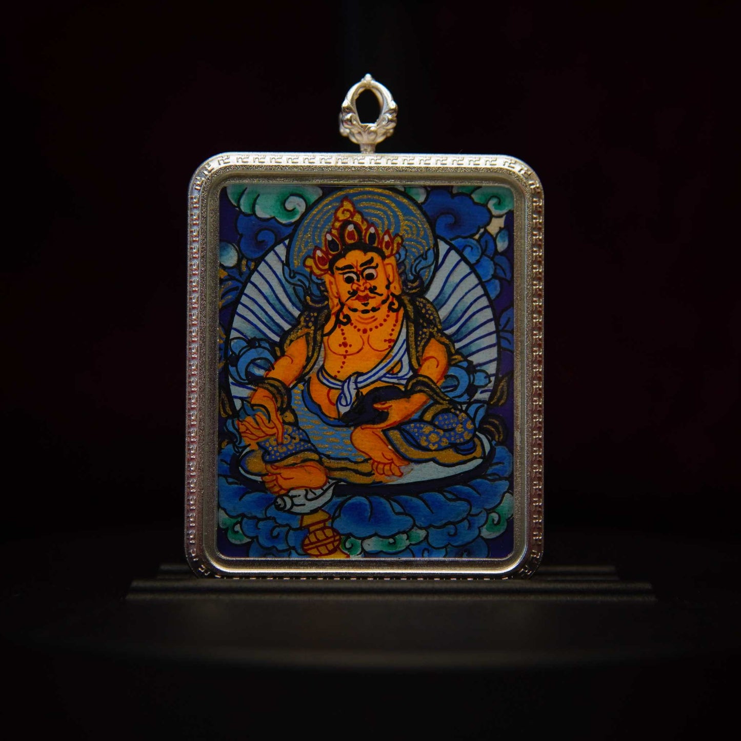 Yellow Jambhala Thangka Pendant Necklace featuring Buddhist God of Wealth for prosperity and abundance, hand-painted with vibrant colors in a silver frame.