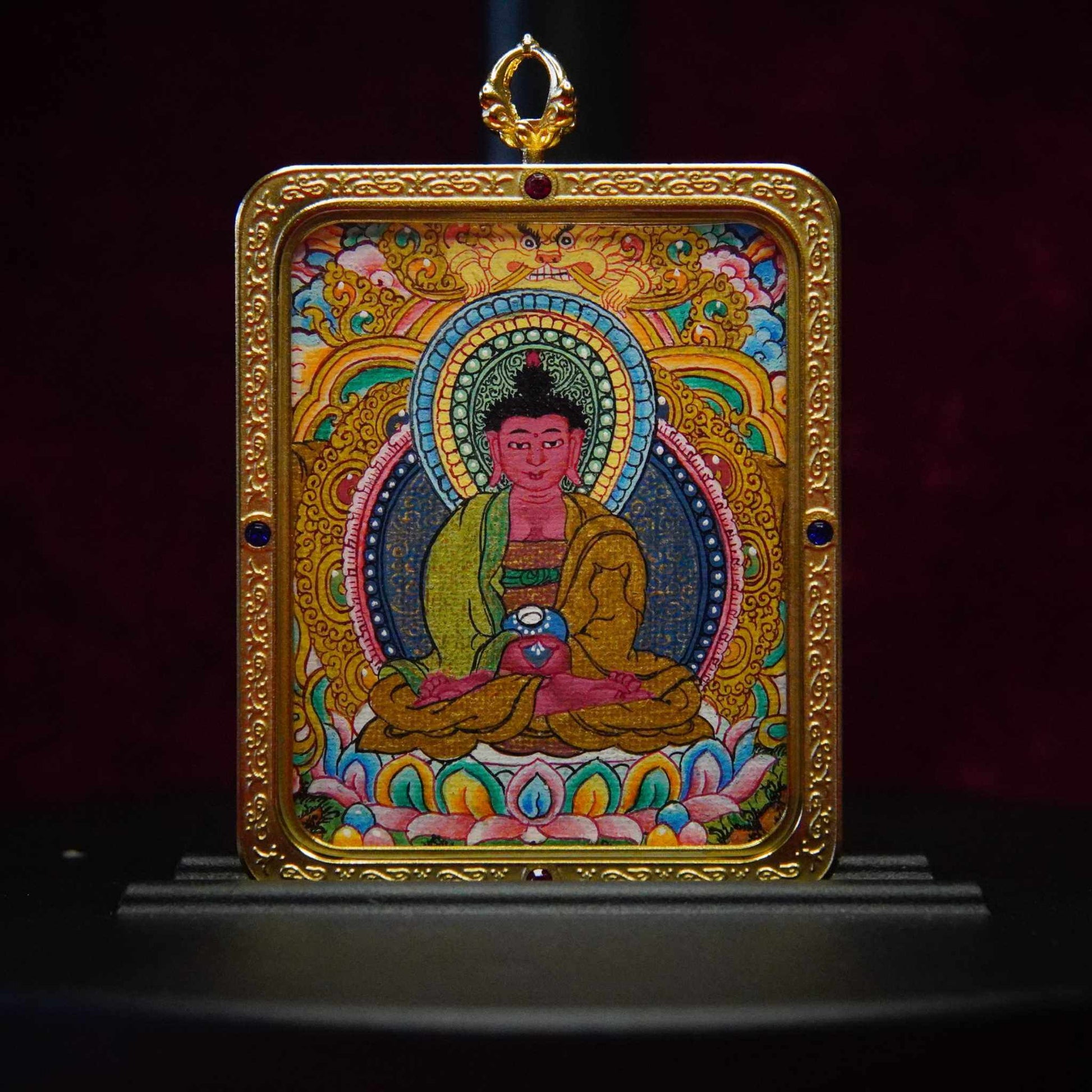 Amitabha Buddha Thangka pendant with intricate Tibetan art, featuring vibrant gold, blue, and green hues on a lotus throne for spiritual seekers.