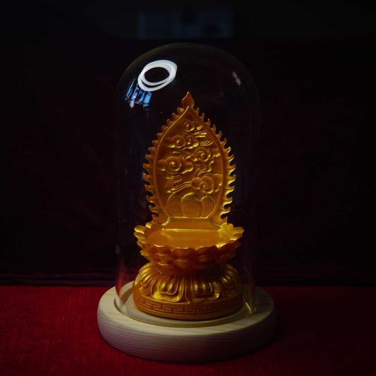 Thangka pendant display stand with golden lotus base under glass dome.