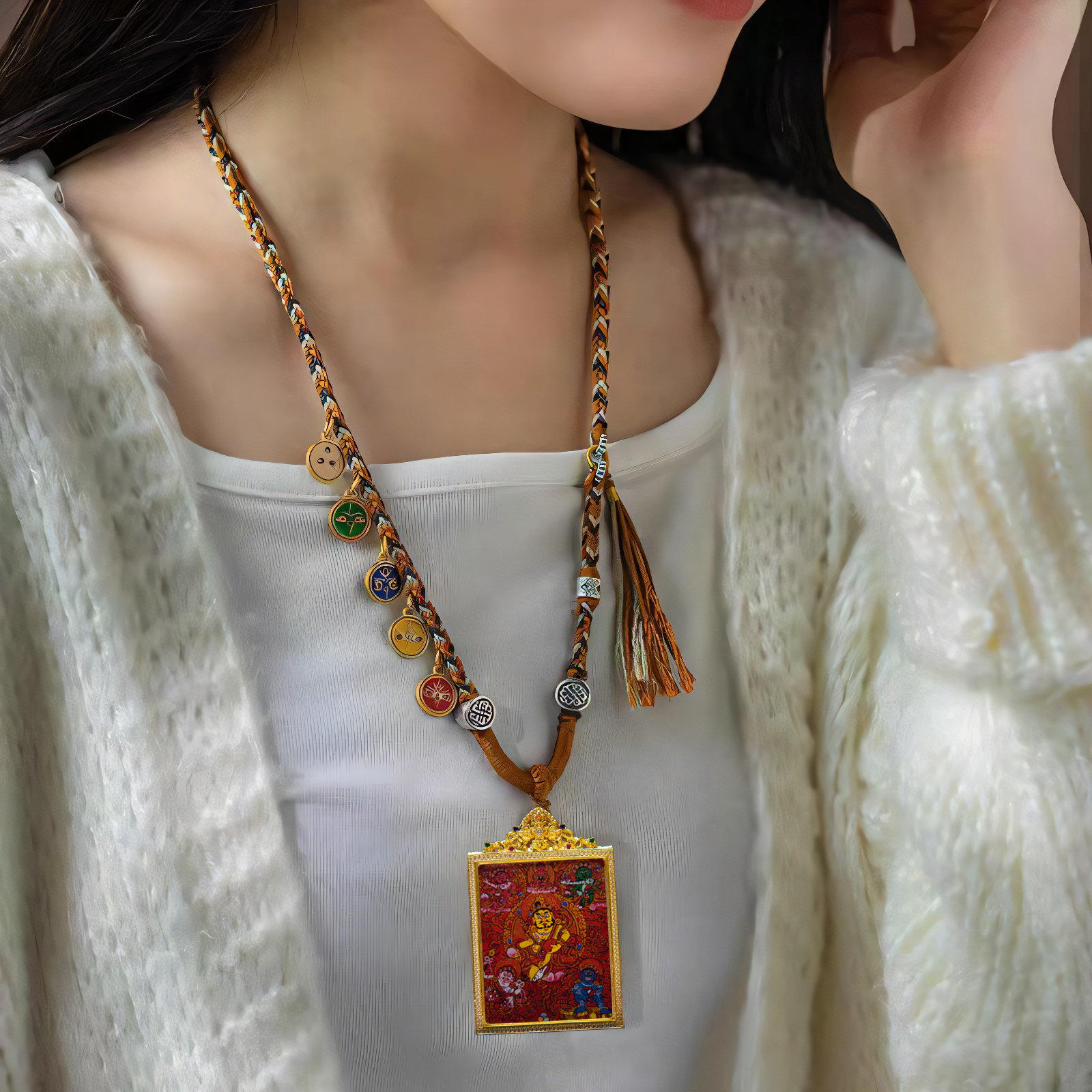 Hand-Painted Red Thangka Six Directions Wealth Gods Pendant on woman wearing white fabric, featuring vibrant colors and intricate Buddhist designs for prosperity and good fortune.