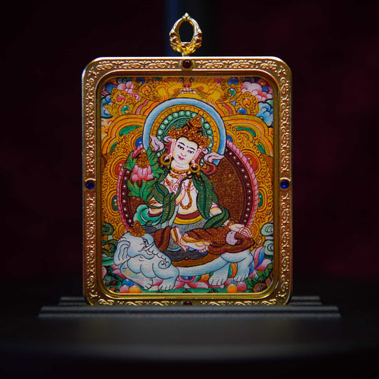 Hand-painted Samantabhadra Bodhisattva Thangka pendant featuring the Wisdom Buddha on a white elephant, adorned with emerald-green robes and gold, set against a blue mandala background.